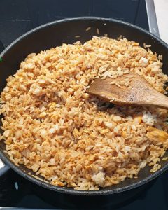 Der Reis wird angebraten und mit Soja Soße abgeschmeckt.